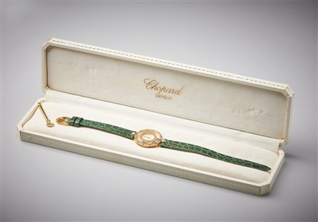  CHOPARD - Orologio da donna in oro giallo 750/1000  modello Happy Diamonds  con diamanti e smeraldi di eccezionale qualità e purezza.