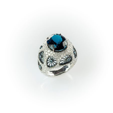 Anello a fascia Salvini in oro bianco con particolare manifattura costituita da un topazio London Blu centrale ed elementi forati sulla superficie di un pavè di diamanti.