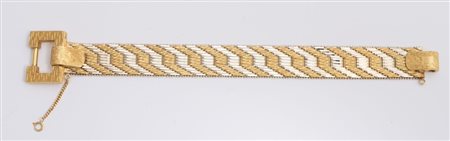 BRACCIALE IN ORO In oro giallo e bianco, disegnato come una fascia morbida...
