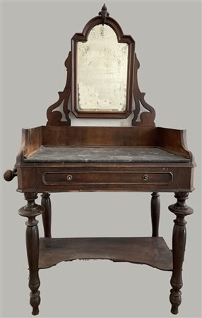 Toilette in noce con fronte a un cassetto e gambe tornite riunite da pianetto,