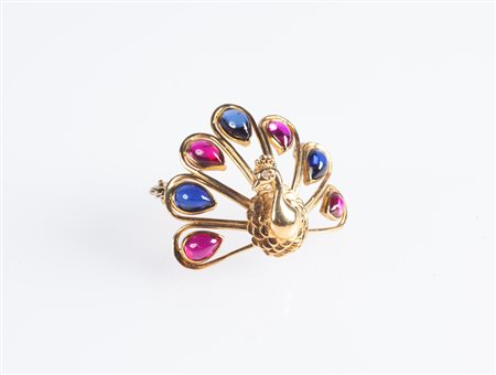  
Spilla a pavone in oro e pietre blu e rosse 
 cm 4x3
