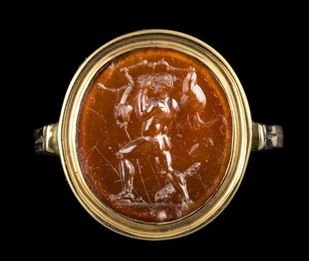 A ROMAN CARNELIAN INTAGLIO SET IN A GOLD RING. HERCULES FIGHTING THE BULL. 
