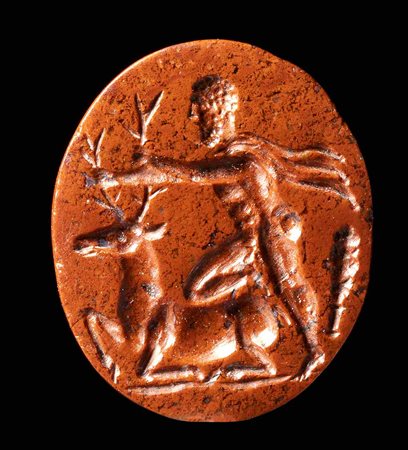 A ROMAN RED JASPER INTAGLIO. HERCULES CAPTURES THE DOE OF CERINEA.