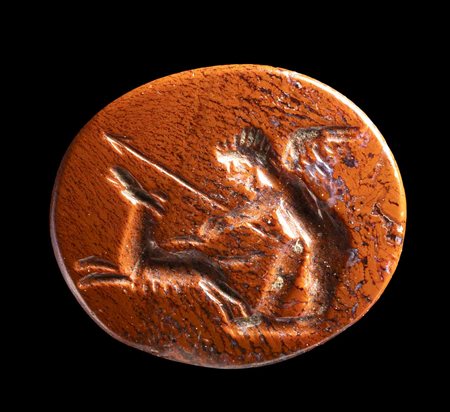 A ROMAN RED JASPER INTAGLIO. EROS HUNTING WITH A DOG.