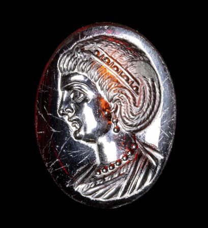 A LATE IMPERIAL ROMAN GARNET INTAGLIO. BUST OF AN EMPRESS.