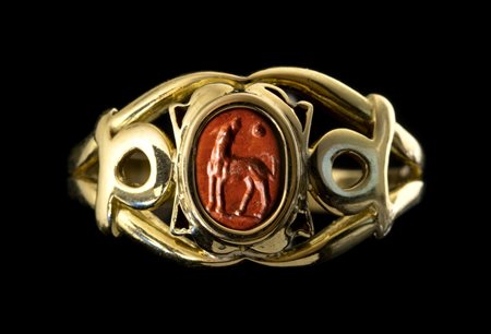 A ROMAN RED JASPER INTAGLIO SET IN A MODERN GOLD RING. A DOG. 