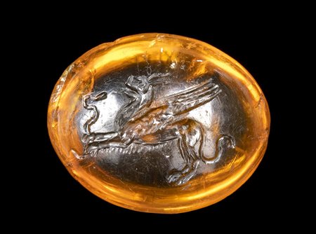A FINE ROMAN CITRINE INTAGLIO. GRIFFIN KILLING A SNAKE. 