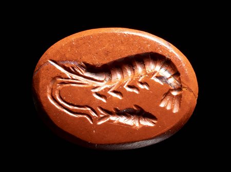 A ROMAN RED JASPER INTAGLIO. PRAWN AND FISH. 