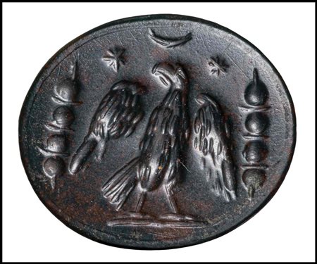 A ROMAN BLOODSTONE INTAGLIO. EAGLE WITH MILITARY INSIGNIA, CRESCENT MOON AND STARS. 