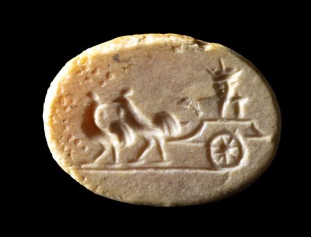A ROMAN BURNT CARNELIAN INTAGLIO. TWO ROASTERS PULLING A CHARIOT DRIVEN BY A CORNUCOPIA. 
