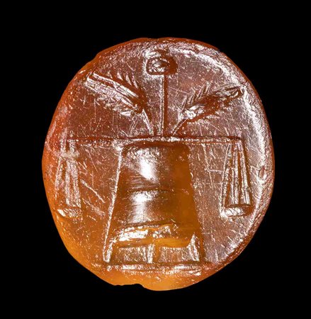 A ROMAN CARNELIAN INTAGLIO. MODIUS WITH A SCALE.