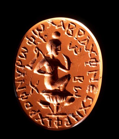 A ROMAN GNOSTIC RED JASPER INTAGLIO. SEATED HARPOCRATES ON A LOTUS WITH INSCRIPTIONS. 