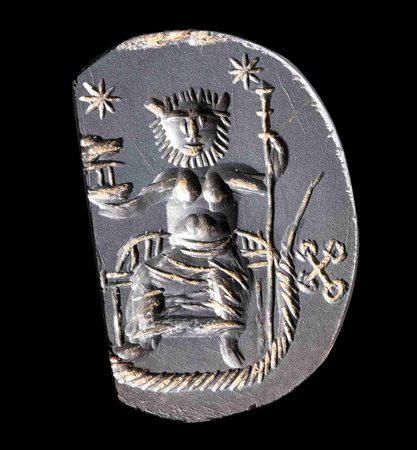 A ROMAN GNOSTIC HEMATITE INTAGLIO. SEATED MALE CHARACTER.