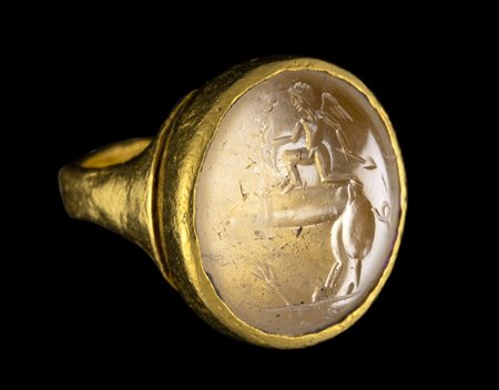 A POSTCLASSICAL ROCK CRYSTAL INTAGLIO SET IN A GOLD RING. EROS RIDING A PHALLUS. 