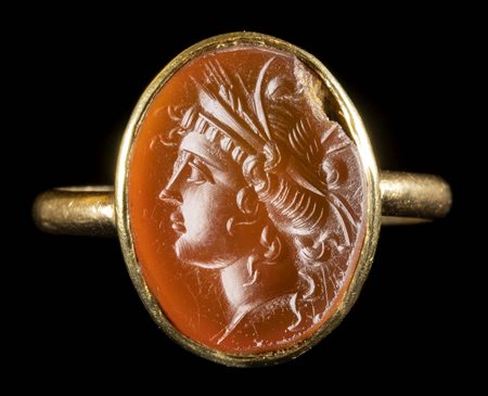 A GRAND TOUR CARNELIAN INTAGLIO SET IN A GOLD RING. HEAD OF PERSEPHONE. 