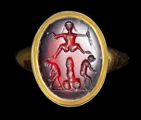 A POSTCLASSICAL CARNELIAN INTAGLIO SET IN A MODERN SOLID GOLD RING. EROTIC SCENE. 