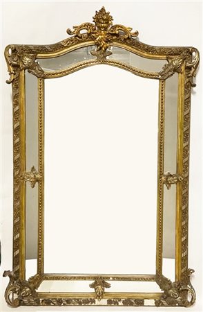 Specchiera in legno intagliato e stucco dorato a doppio ordine, decoro a volute