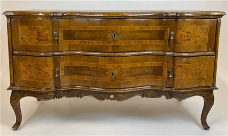 Comò con fronte mosso a due cassetti lastronato in noce, radica di noce e filet