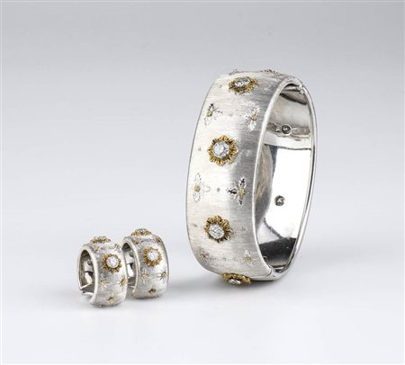  
MARIO BUCCELLATI: bracciale a fascia rigida e paio di orecchini in oro e diamanti 
 