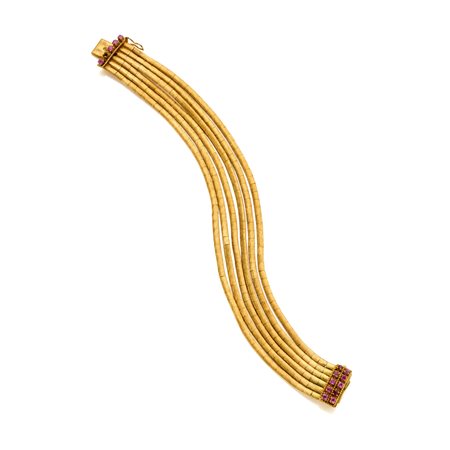 Bracciale in oro giallo 18 Kt satinato rifinito con con rubini rotondi...