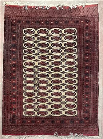 Tappeto Boukhara, Pakistan, secolo XX. Decoro con quattro file di Gül rossi su