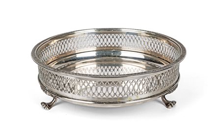 Vaschetta circolare racchiusa da ringhierina traforata, tre piedi a zampa...