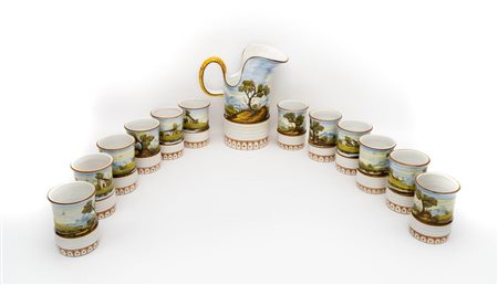 Brocca in maiolica con 12 bicchieri firmata "L.C. Da Castelli"   