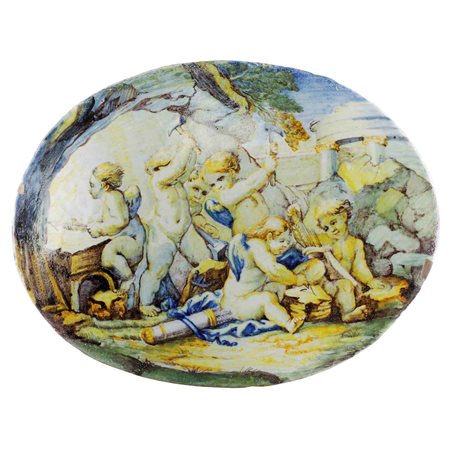 BARTOLOMEO TERCHI (bottega di)
(Roma 1691-Viterbo 1766)
 Amorini entro paesaggio con rovine, placca in maiolica policroma
