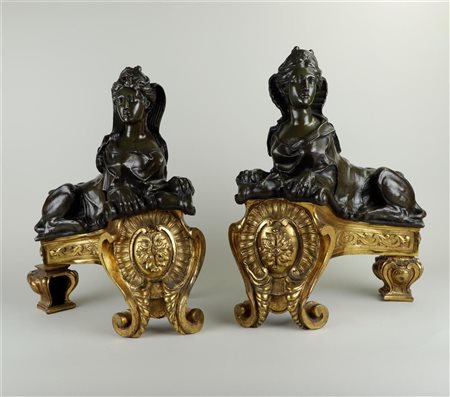 A set of large fire-gilded andirons with dark patinated bronze sphinxes on...