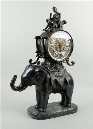 A bronze, rococo revival elephant clock on green marble base, with enamelled...