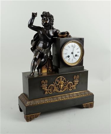 A "Charles X" mantel clock with bronze putto. France, 19th century. 44 x 33 cm.