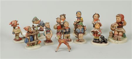 A collection of twelve Hummel figurines, all marked Goebel (on the bottom).