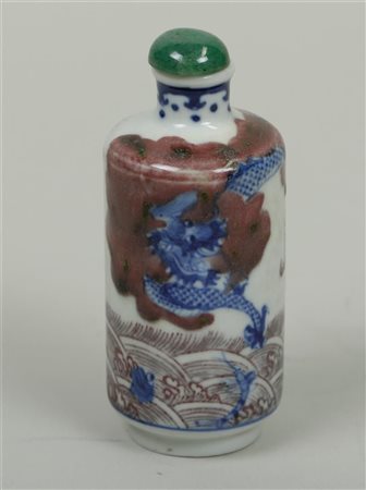 A porcelain 'Iron red' snuff bottle with dragon decoration, marked Yongzheng....