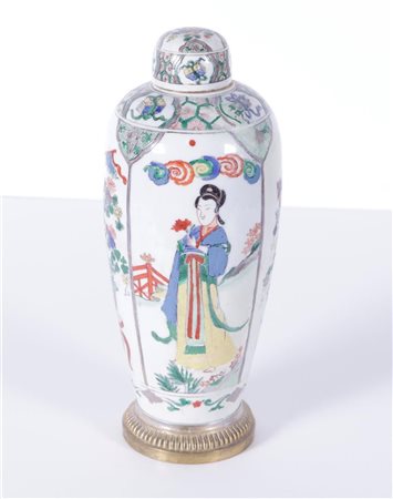 A porcelain famile verte lidded vase decorated with long Elizas and flowers...