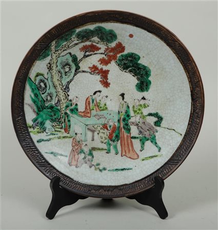 A Nanking earthenware dish decorated with various figures, marked on the...