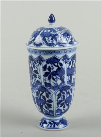 A porcelain bell-shaped covered vase with floral decoration in borders....