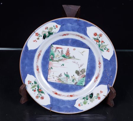 A porcelain Famille-verte plate, powder-blue decor with landscape decor. ±...
