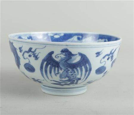 A porcelain bowl decorated with dragons and phoenixes, symbol on the bottom....