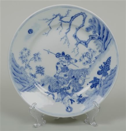 A porcelain plate with a figure on an elephant, marked in period. China,...