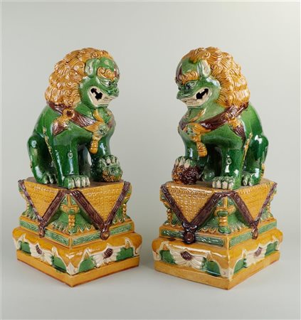 A set of (2) Sankai, green glazed, earthenware foodogs. 20th century.H.: 47,5...