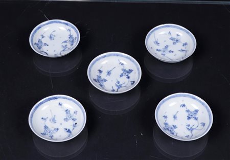 Five porcelain saucers with floral decor between which two birds. China, 18th...