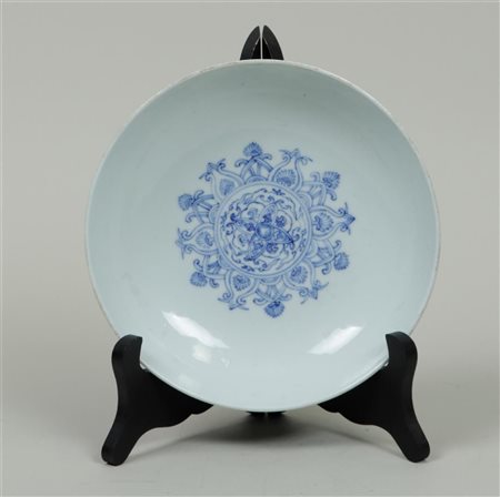 A porcelain bowl with floral decoration in the centre and back, marked...