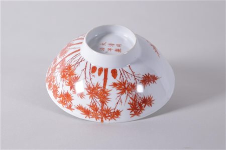 A porcelain iron red bowl decorated with trees, marked Tonghzi. China, 20th...