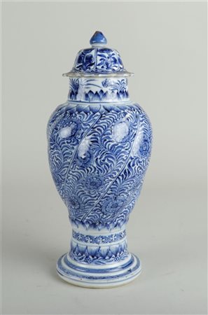 A porcelain lidded vase with twisted relief decoration in which a rich floral...