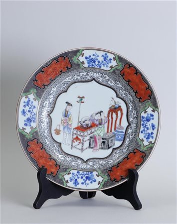 A porcelain famile noir plate with famile decoration in centre of various...