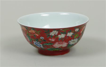 A porcelain famille rose bowl decorated with flowers, Chinese text on the...
