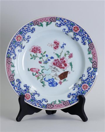 A porcelain famile rose plate decorated with peonies and encre de Chine...