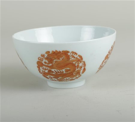 A porcelain iron red bowl decorated with dragons in medallion, marked...