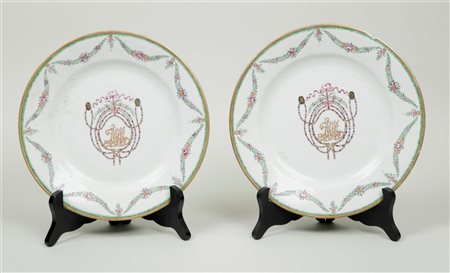 Two porcelain famile rose plates painted with coat of arms in the centre....