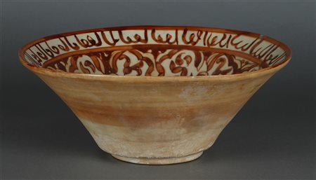 An earthenware nishapur bowl with floral decoration and decorated with a...